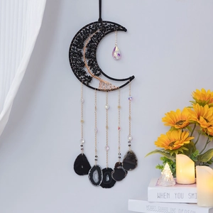 Detailed view of moon-shaped dream catcher with black crystals and agate stone pendants