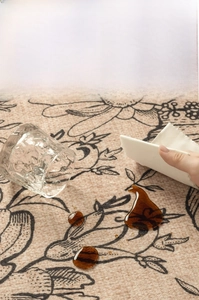 Detailed macro view showing the 3x waterproof effect on vintage floral carpet surface