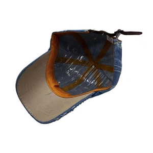Inside view of denim baseball cap with rhinestone flower and adjustable leather strap