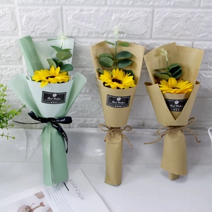 Detailed view of artificial sunflower bouquets in green and kraft paper with eucalyptus