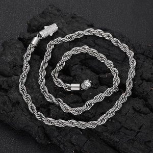 Men's 6mm silver stainless steel rope chain necklace with a diamond buckle on dark stone