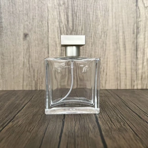 Detailed view of square 25ml transparent glass perfume spray bottle with silver cap