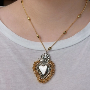 Sacred heart pendant necklace with gold beads on a silver and gold two-tone chain