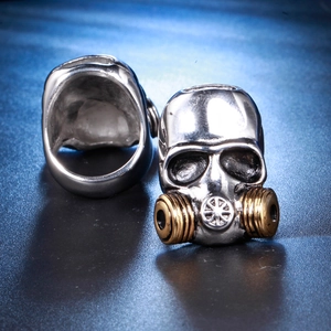 Macro shot of two-tone biker skull gas mask ring in silver and gold stainless steel