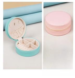 Detail view of mini round PU jewelry box with zipper, showing interior and exterior design