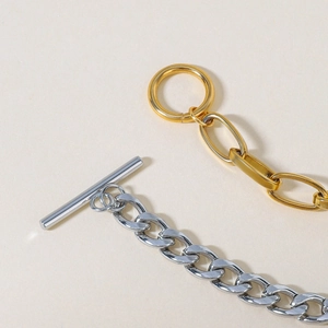 Detailed macro of 18K gold and silver steel Cuban links with heart OT buckle clasp