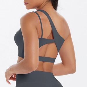 Detailed back view of dark grey sports bra with irregular straps and hollow cross design