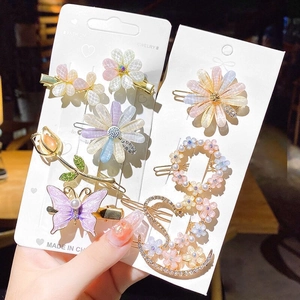 Detailed set of floral hair clips with rhinestones, pearls and sweet pastel motifs