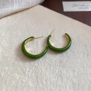 Minimalist dark green enamel C-shaped hoop earrings with elegant gold-plated finish