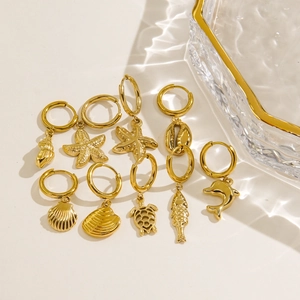 14K gold plated ocean theme hoop earrings featuring starfish and seashell pendants