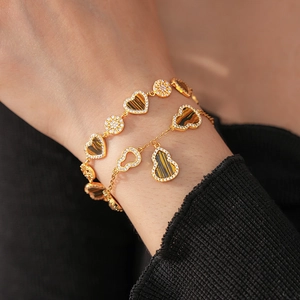 Detail of 18K gold plated bracelet with tiger eye heart and zircon gourd charms