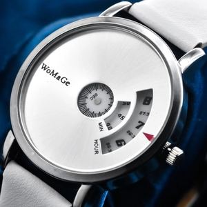 Close-up of minimalist rotating dial watch with silver case and white strap on blue fabric