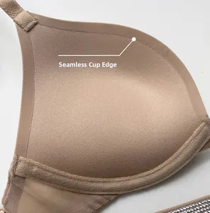 Macro detail of seamless cup edge and rhinestone straps on skin-tone push-up bra
