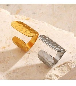 Detail shot of 18K gold and silver plated open rings with textured hammered metal finish