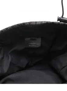 Detail of checkered hat interior with care label and adjustable drawstring