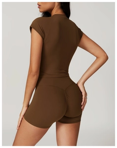 Detail view of high-waist fitness shorts with ruched seam for push-up effect