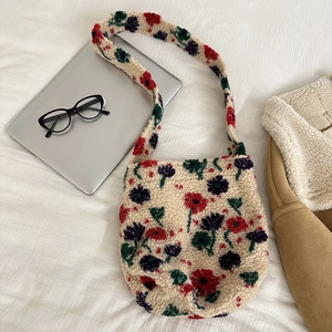 Close-up of fluffy beige teddy plush shoulder bag with colorful floral embroidery detail