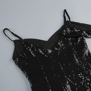 Detail of black sequin dress featuring rhinestone straps and adjustable metal buckles