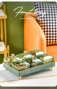 Detail of a green six-compartment glass snack tray with crystal knobs and base