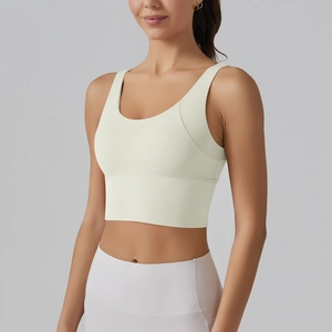 Detail view of seamless cream sports bra with wide straps and deep U-neckline