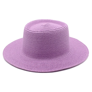 Detailed top view of purple woven straw boater hat with fine spiral texture and flat brim