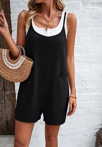 Detail view of black sleeveless playsuit with functional front pockets on a model