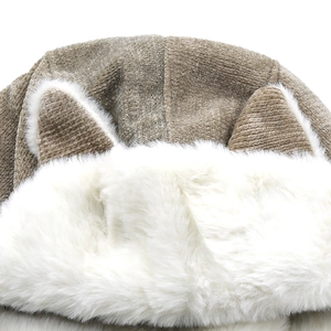 Detailed close-up of khaki corduroy fabric and warm white faux fur lining on winter hat