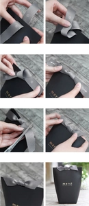 Step-by-step tutorial for tying a gray ribbon on a minimalist black gift box with merci logo
