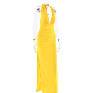 Detail of yellow halter neck maxi dress featuring a deep V-neckline and high side slit