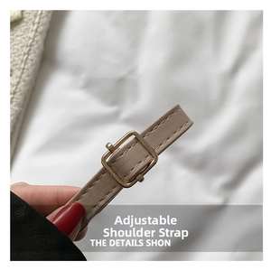 Detail of beige faux leather adjustable shoulder strap with golden metal buckle