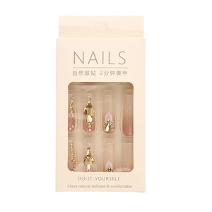 Pink gradient press-on nails with luxury gold rhinestones and metallic charms