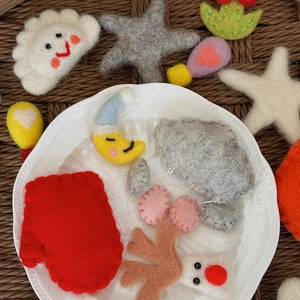 Handmade wool felt charms in cartoon shapes like deer and stars for DIY Christmas crafts
