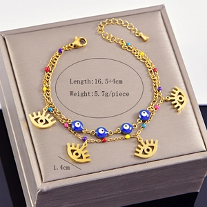 Detailed view of gold double-layer bracelet with blue evil eye beads and lash charms