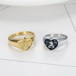 Detailed macro view of gold and silver stainless steel rings with angel heart reliefs