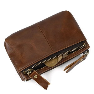 Detailed top view of brown genuine leather coin purse with triple zippers and coins