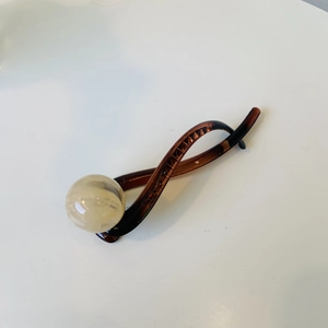 Elegant retro hair bun maker with tortoiseshell pattern and a cream marble bead detail