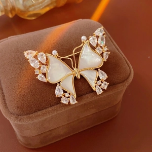 Exquisite 18k gold butterfly brooch with mother of pearl and shimmering zircons