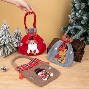 Detail showing felt Christmas gift bags with bells and embroidery in a festive setting