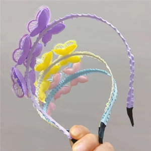 Detailed view of handmade embroidered butterfly headbands for girls in various colors