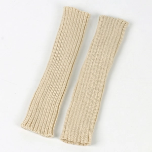 Detailed macro view of the cream rib-knit texture and soft stitch patterns on warm arm sleeves