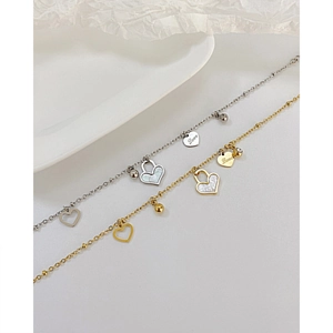 Detail of waterproof stainless steel heart bracelets with Love engraving and shell inlay
