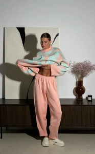 Detail of pink and mint green jacquard knit sweater with drawstring joggers for women