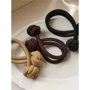 Elastic high ponytail hair ties set in beige and brown colors with knot detail