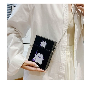 Close-up of black crossbody box bag with silver chain and purple ghost print