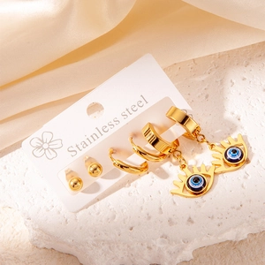 Detail of gold stainless steel earring set with blue evil eye pendant on stone base