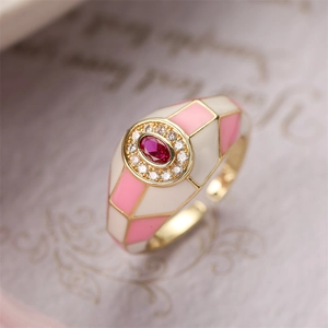 Detail of 18K gold ring with pink enamel checkerboard and red crystal stone