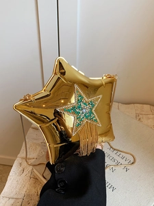 Detail of gold star acrylic clutch with green rhinestone fringe and metal chain strap