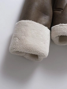 Detailed view of the dark brown suede sleeve with white faux shearling lining