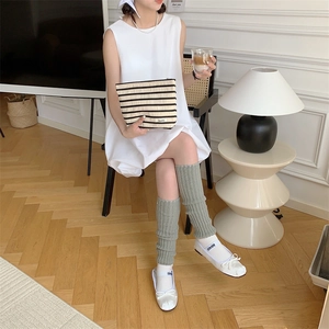 Chic black and white striped knitted clutch bag styled with minimalist fashion outfits