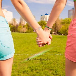 Outdoor shot of friendship magnetic bracelets with crown charms for best friends or couples